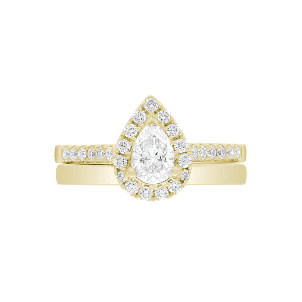 Pear Cut Halo Ring in yellow gold, laying flat with a matching yellow gold wedding band,on A WHITE SURFACE WITH A WHITE BACKGROUND