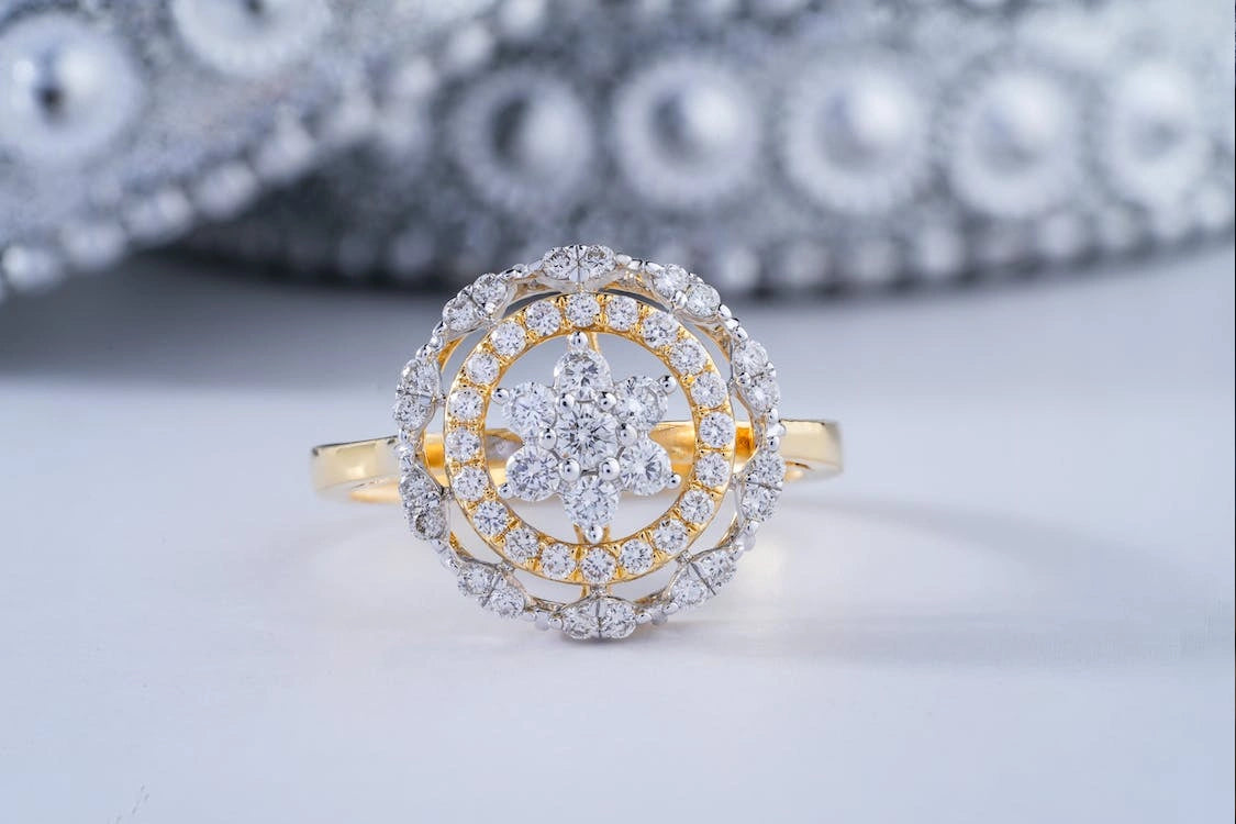 A stunning gold with diamond engagement ring besides some ornaments