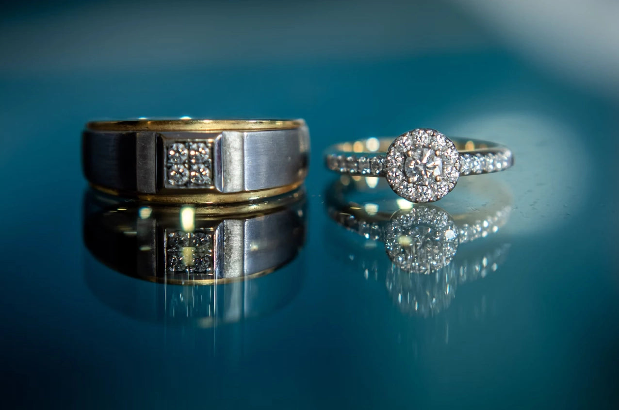 Two beautiful engagement rings placed on blueish background