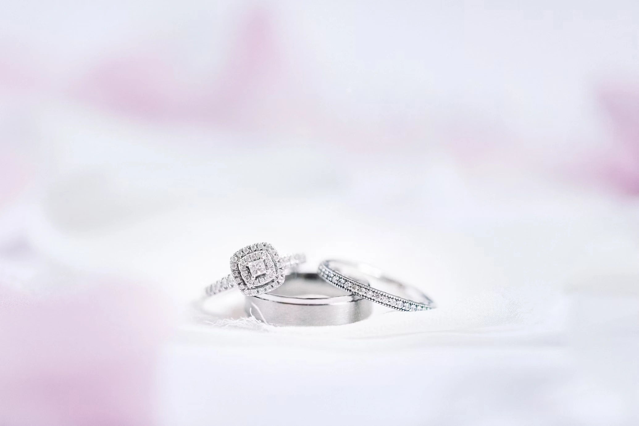 A diamond engagement rings with pinkish white background