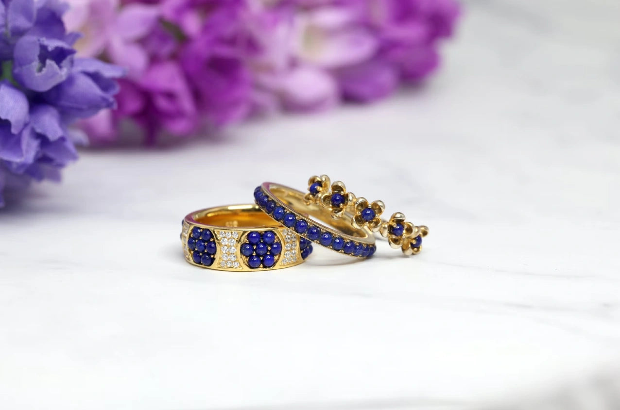 Two beautiful blue stoned engagement rings placed with a well decorated background