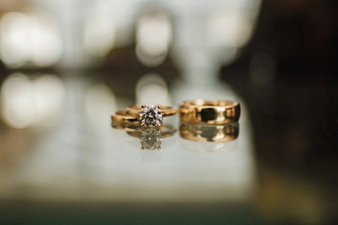 Two Gold engagement rings in a lightened place