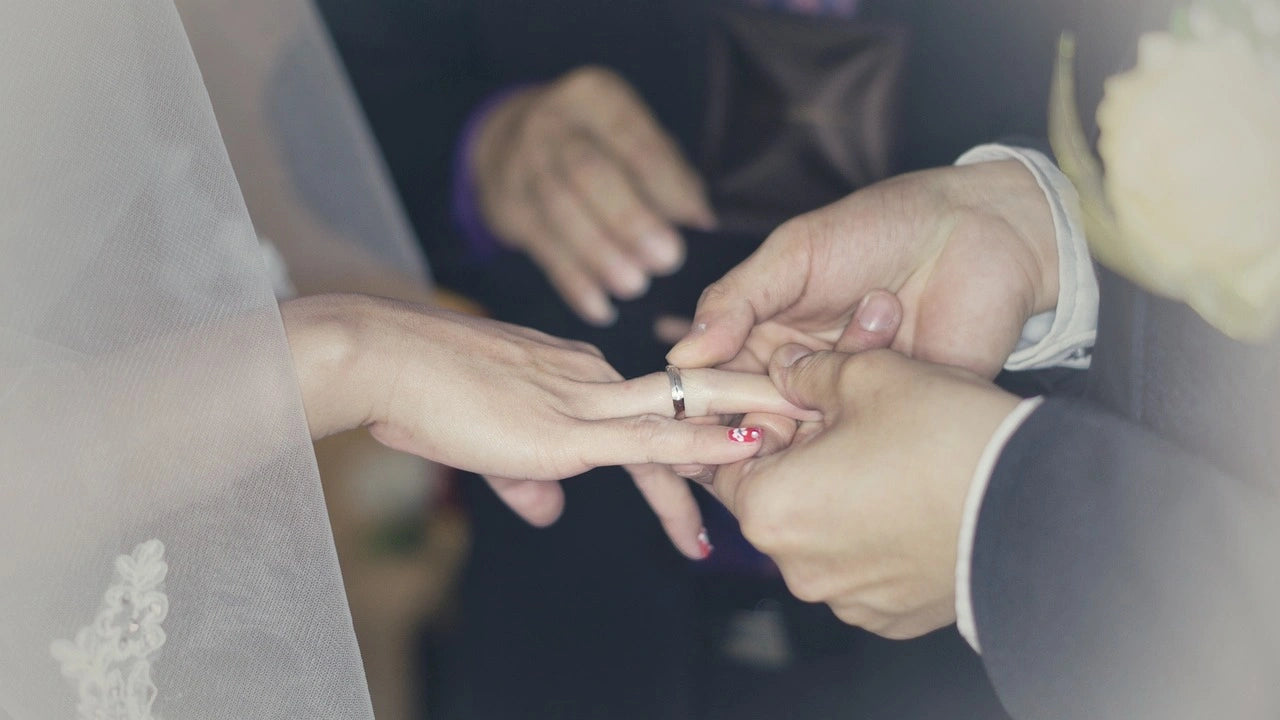 A groom put engagement ring to his bride in their engagement ceremony