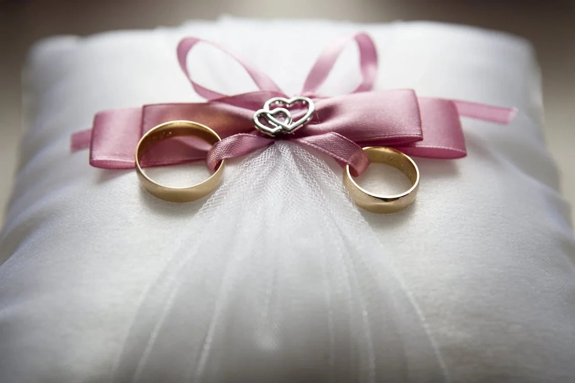 Two engagement rings placed on a gift box