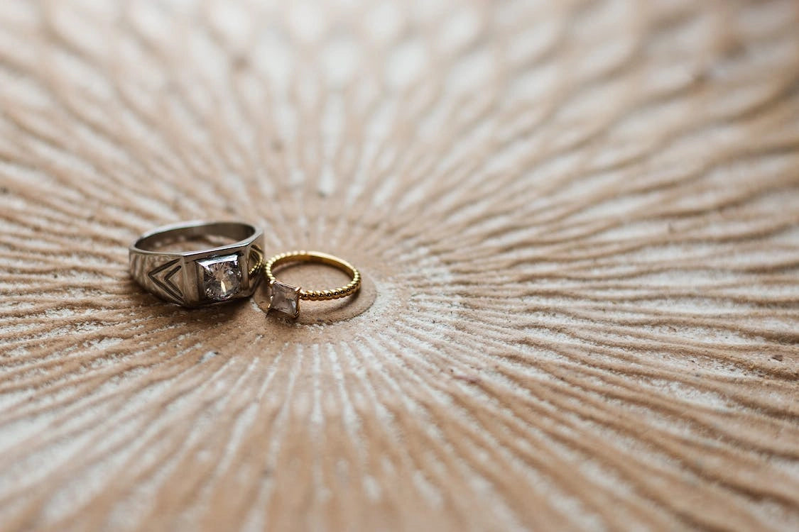 Engagement rings are placed on a designed wooden table