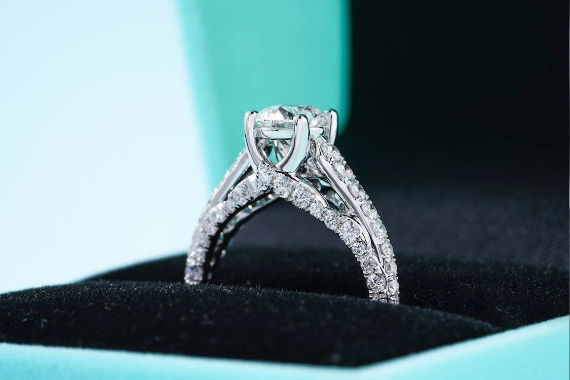 A stunning diamond engagement ring inside the black sheet