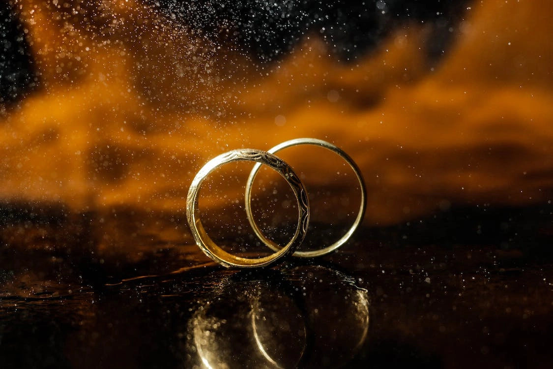 Two engagement rings with a soiled background