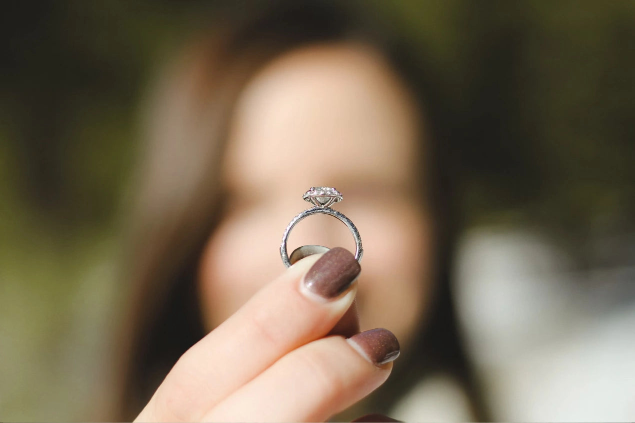 Shallow focus photography of women holding a diamond ring