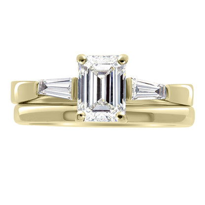 Emerald Cut With Tapered Baguettes in yellow gold with matching plain wedding ring
