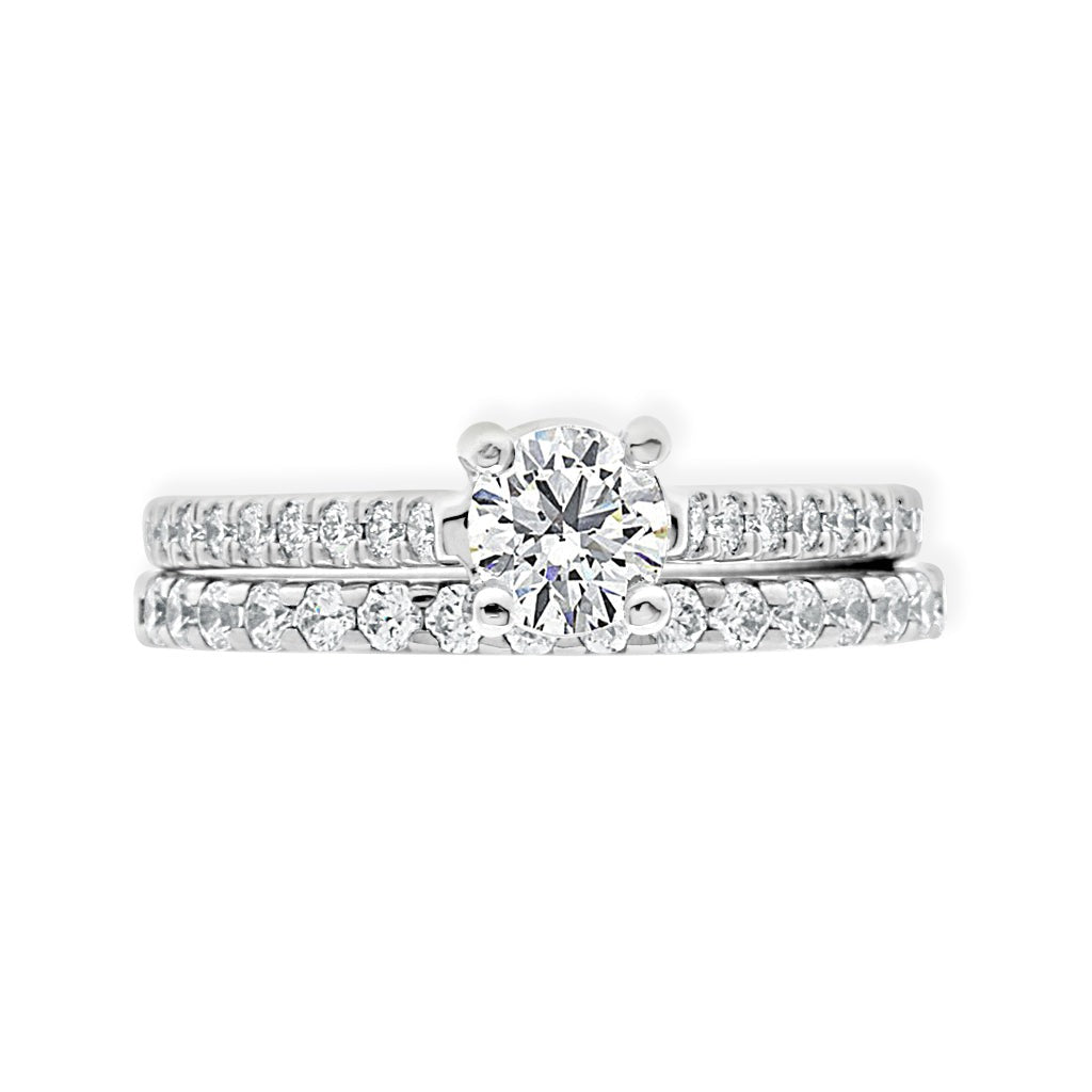 Castell  Set Diamond Ring in white gold laying flat with matching diamond wedding ring