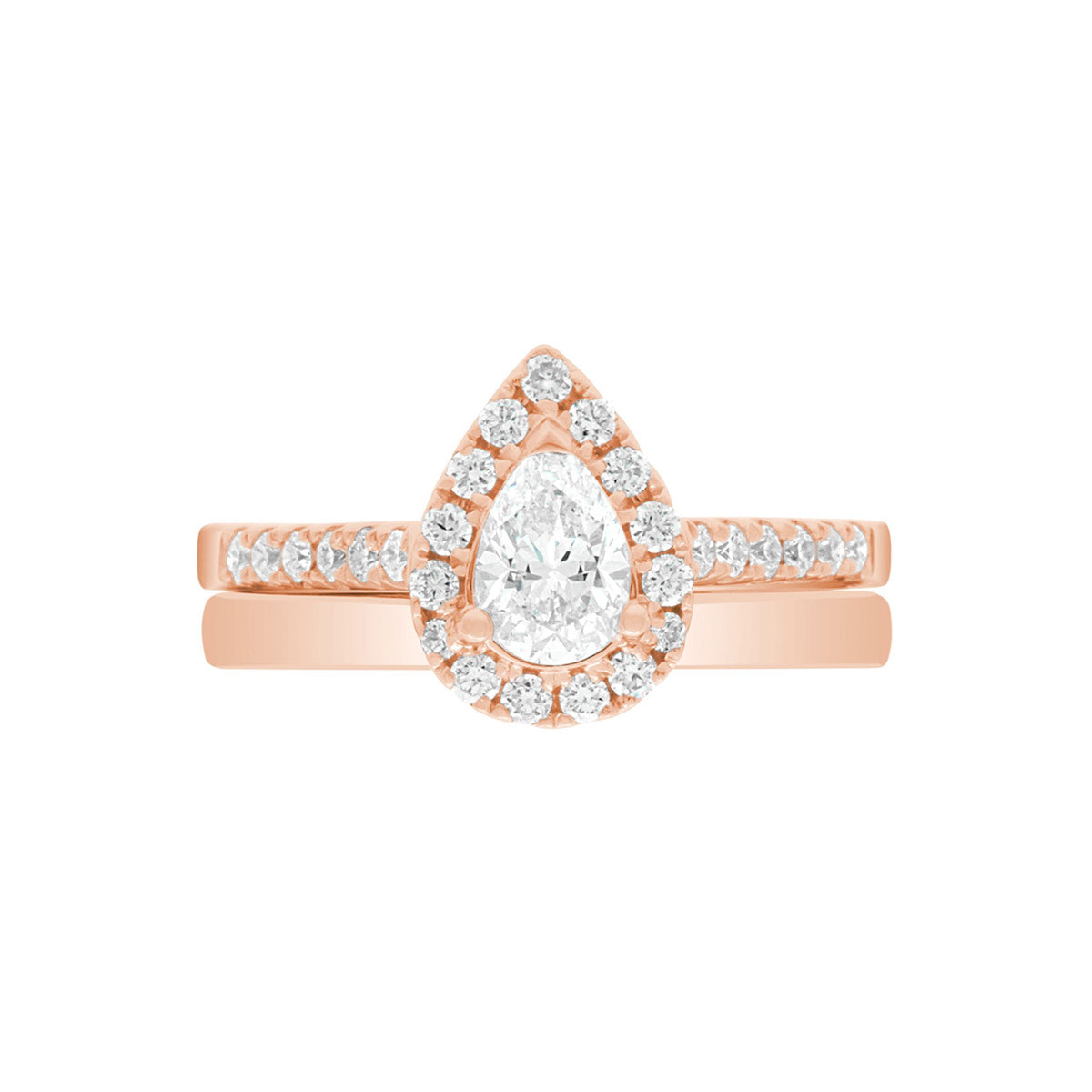 Pear Cut Halo Ring in rose gold, laying flat with a matching rose gold wedding band,on A WHITE SURFACE WITH A WHITE BACKGROUND