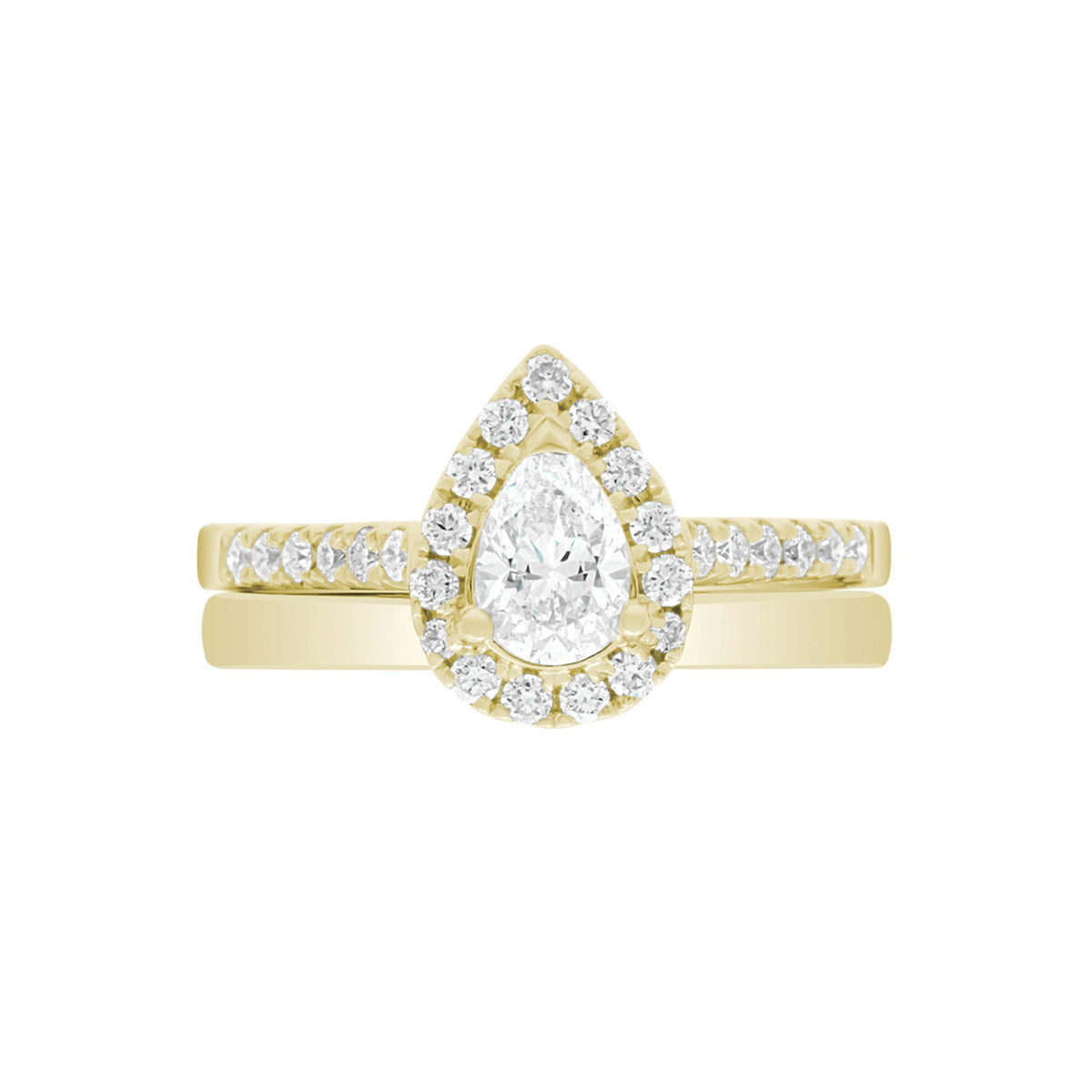 Pear Cut Halo Ring in yellow gold, laying flat with a matching yellow gold wedding band,on A WHITE SURFACE WITH A WHITE BACKGROUND