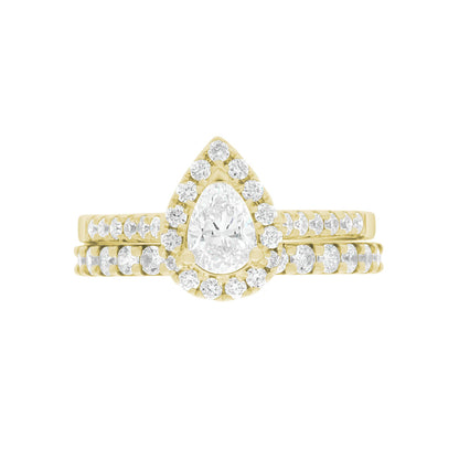Pear Cut Halo Ring in yellow gold, laying flat with a matching yellow gold diamond set wedding band,on A WHITE SURFACE WITH A WHITE BACKGROUND