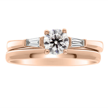 Round Solitaire With Tapered Baguettes made from rose gold with a plain wedding ring