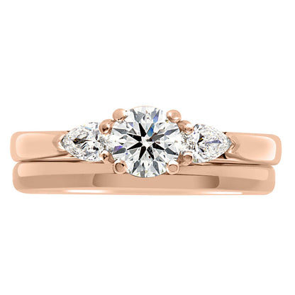 Round and Pear Diamond Ring in rose gold with a plain wedding ring