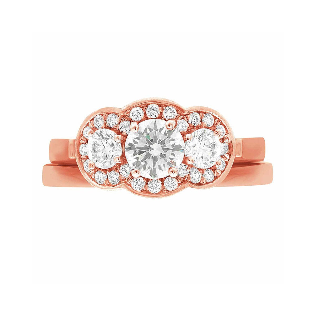 Three Halo Engagement Ring in rose gold, lying flat with a white background and featuring a matching plain wedding ring