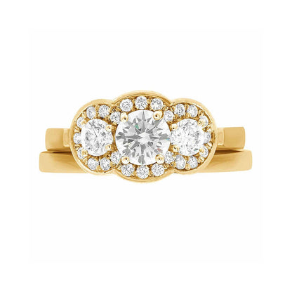 Three Halo Engagement Ring in yellow gold, lying flat with a white background and with a matching wedding ring