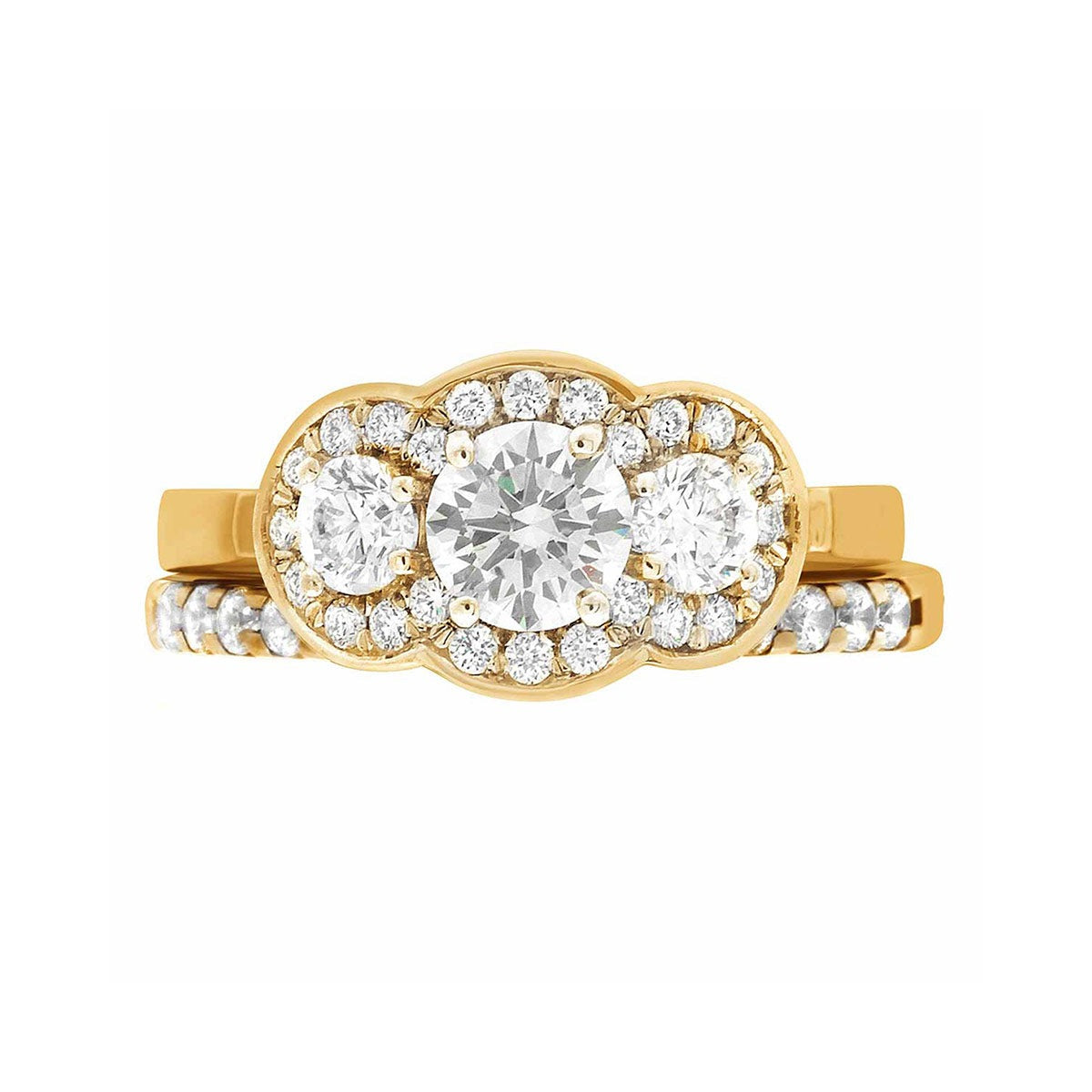 Three Halo Engagement Ring in yellow gold, lying flat with a white background and with a matching diamond set wedding ring