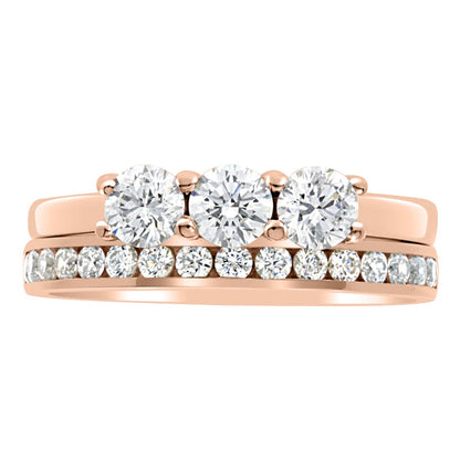 Three Stone Engagement Ring made of rose gold with a diamond wedding ring