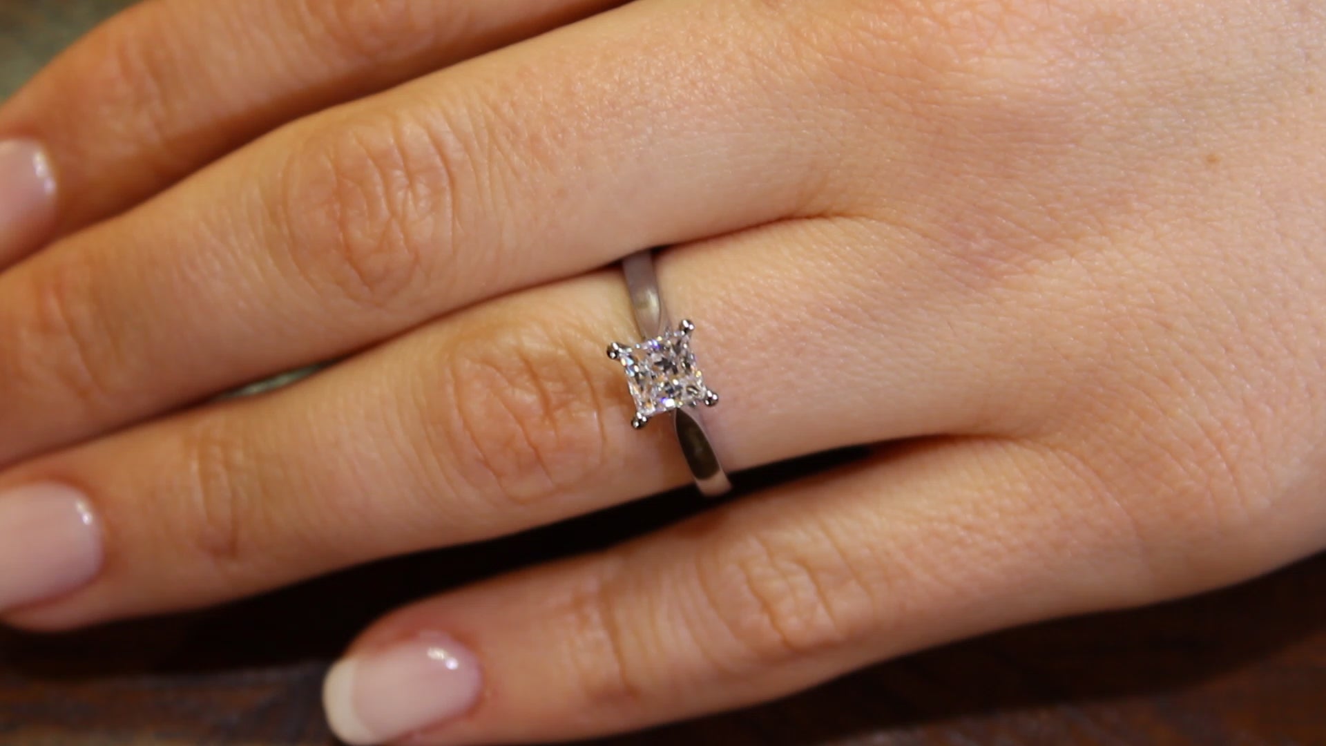 Princess Cut Diamond Ring in white gold on a womans ring finger