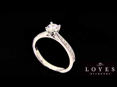 Solitaire With Tapered Diamond Band on black background