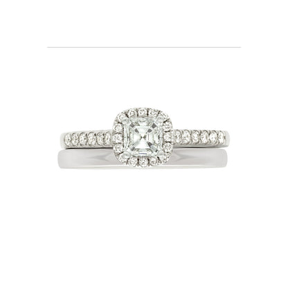 Asscher Halo Diamond Ring in white gold pictured with a plain white gold wedding ring