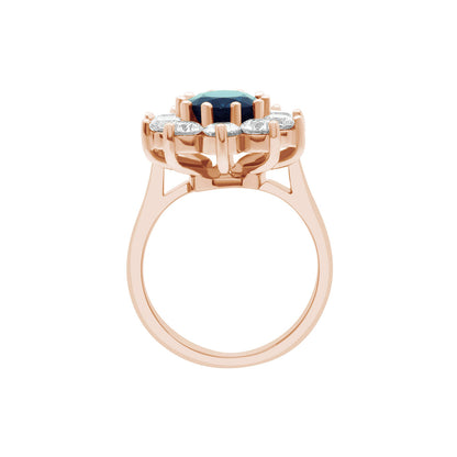 Sapphire Engagement Ring in rose gold with a cluster of sparkling white diamonds in an upright position