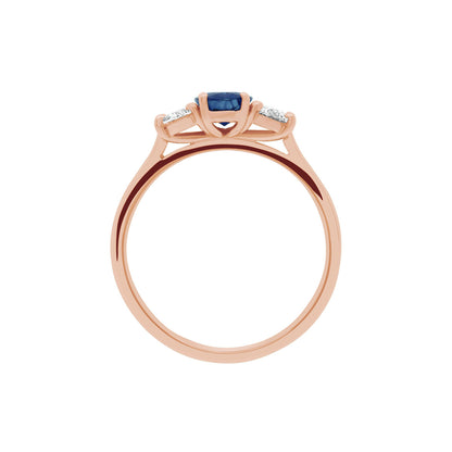 Sapphire &amp; Diamond Trilogy Ring made from red gold in an upright position