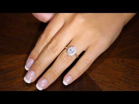 video of a Cluster Engagement Ring with diamond shoulders in white gold on a lady&