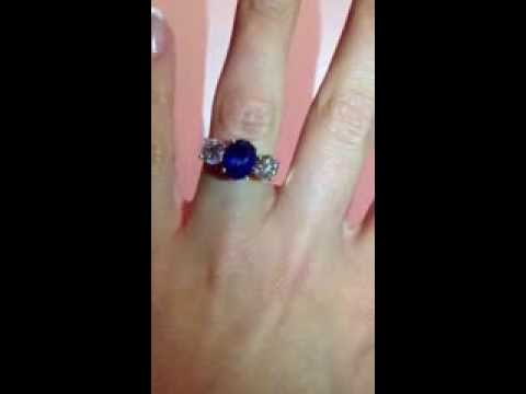 Sapphire &amp; Diamond Trilogy Ring made from white gold on a womans finger