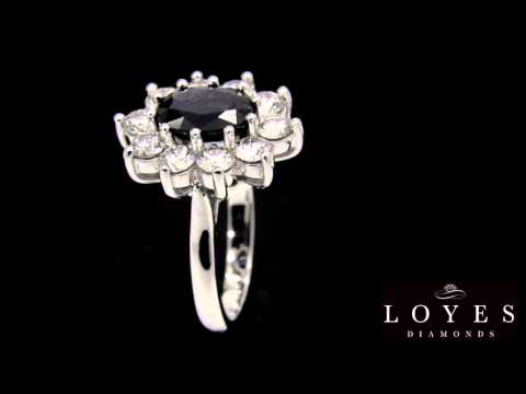 Video of a Sapphire Engagement Ring in white gold with a cluster of sparkling white diamonds on a black background