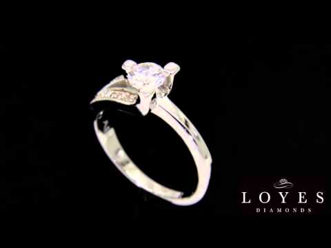 Unusual Diamond Engagement Ring Set in platinum rotating in front of a black background