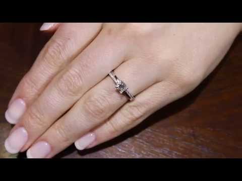 Promise Ring Style WITH A PRINCESS CUT CENTRE IN WHITE GOLD ON A WOMANS HAND