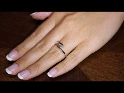 Princess Solitaire Engagement Ring in a white gold tension setting on a ladys hand