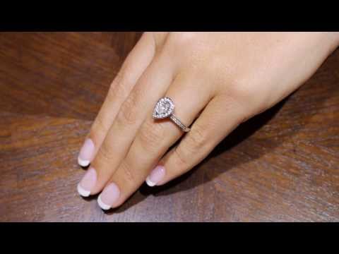Pear Shaped Halo Engagement Ring in white gold on a ladys left hand