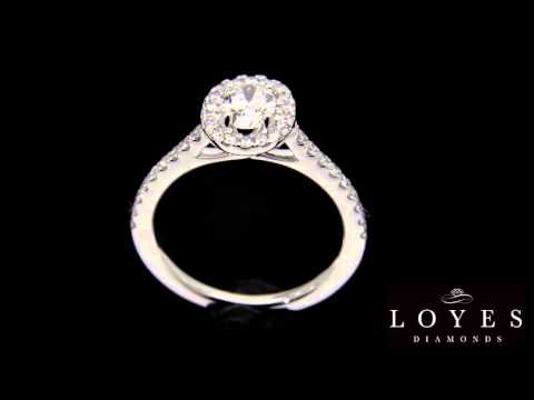 Oval Halo Engagement Ring made of white gold revolving with a black background